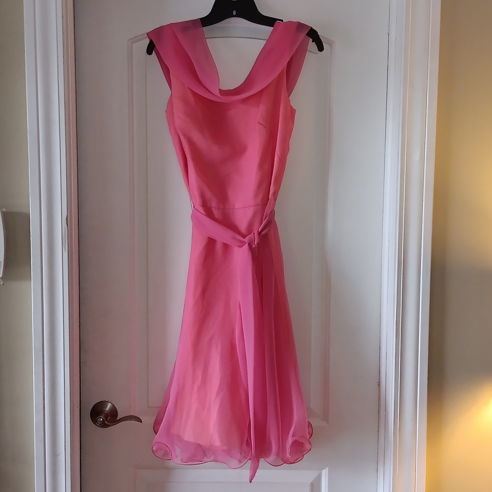 Pink dress with sash and ruffles at the bottom
